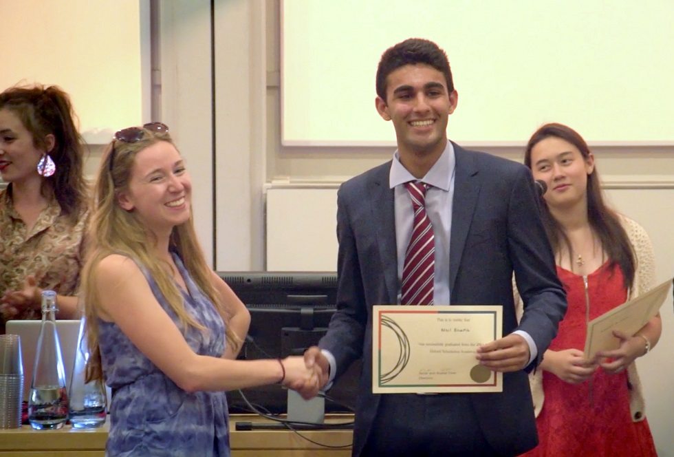 Student holding an Oxford Summer School certificate