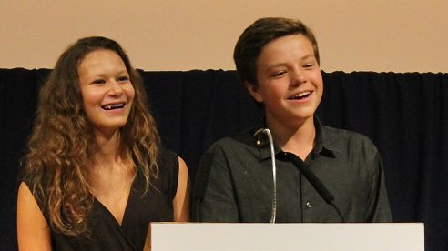 Two young teen students sharing a speech at the Oxford graduation ceremony