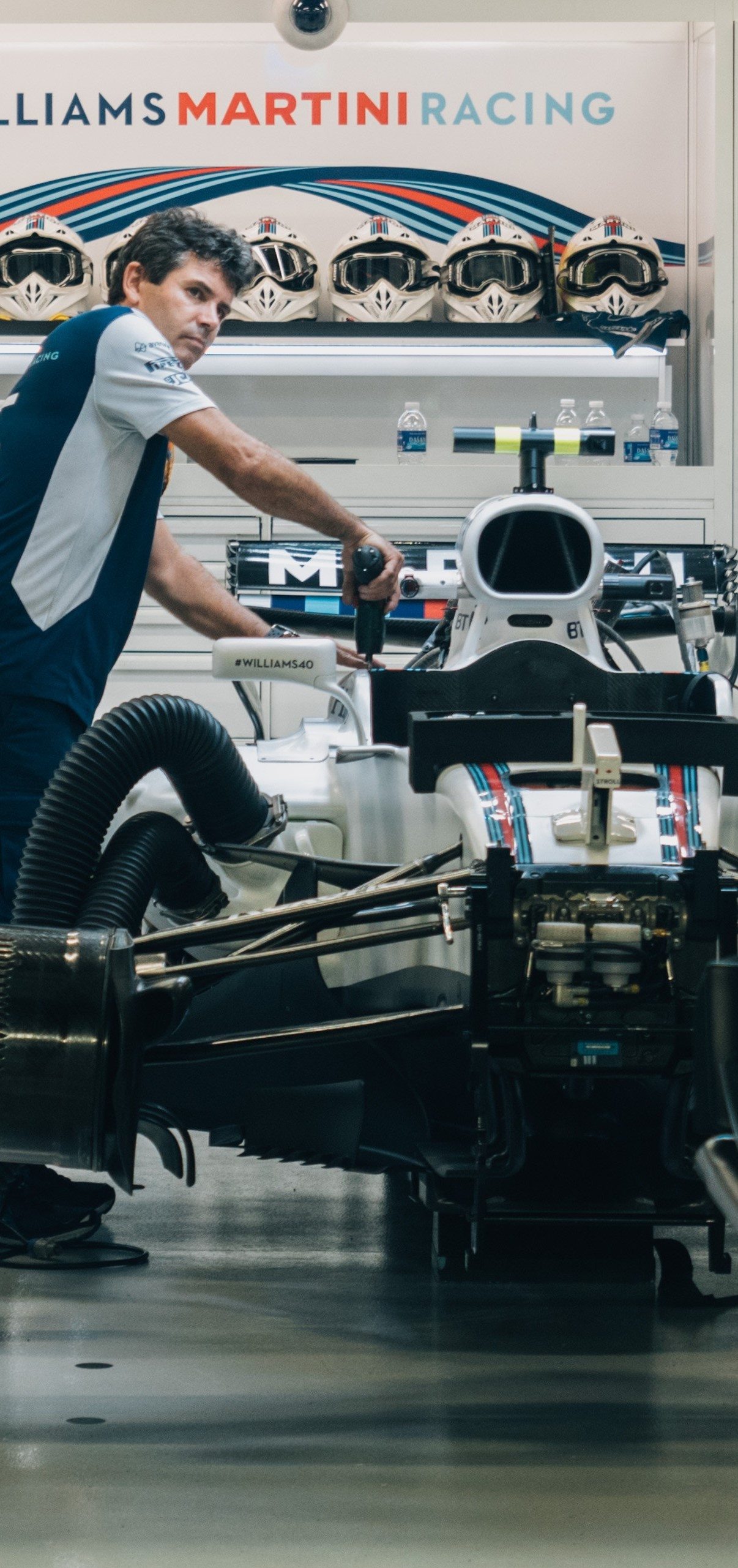 A mechanic fixing a Formula 1 car