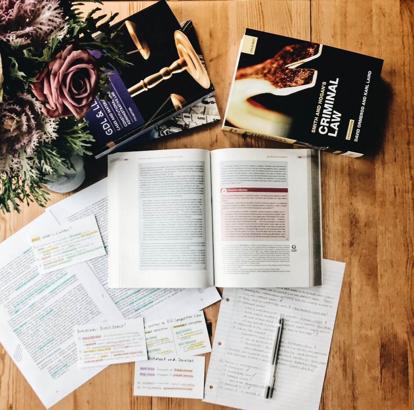 Law student's textbooks for GDL and criminal law on a table.