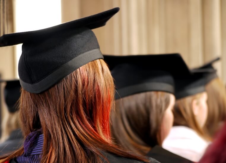 Students in line, wearing graduation cap