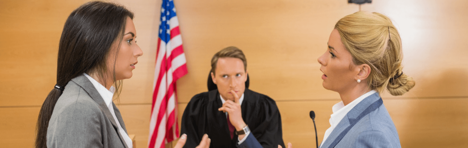 Two young students part taking in a moot court competition in front of a judge