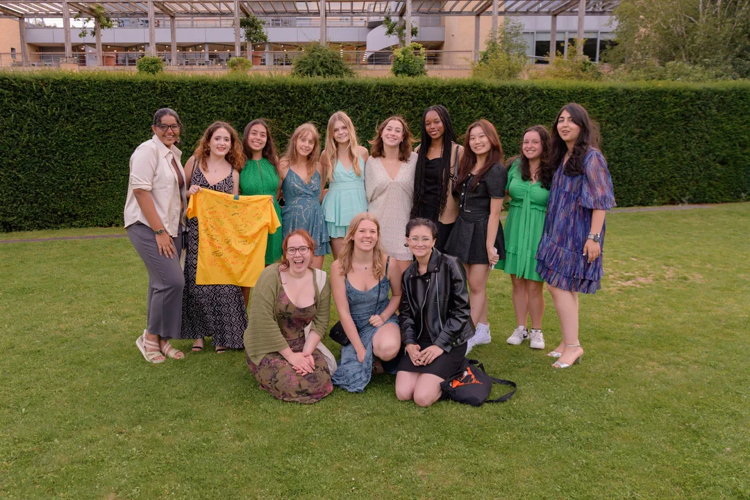 Group of summer school students, holding a signed t-shirt