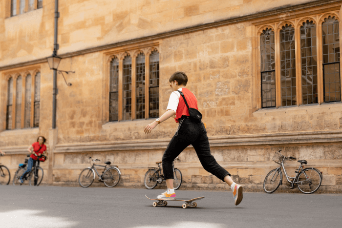 An international student skateboarding on the Oxford University campus