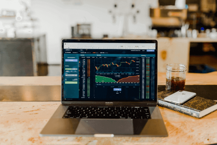 A laptop showing an online market and trading graph