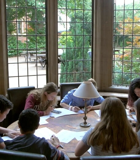 A group of students studying for their business summer school class