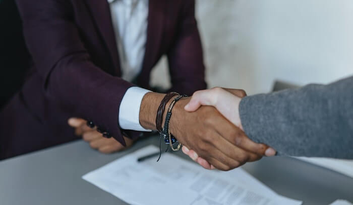 A student shaking hands with a hiring manager in a job interview