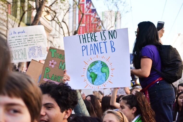 Students holding an environmental sign saying "There is no planet B"