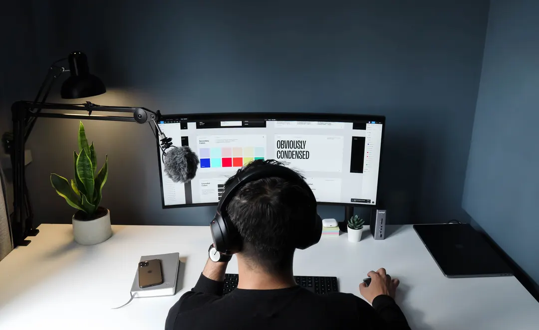Person sitting at a PC, working on graphic design