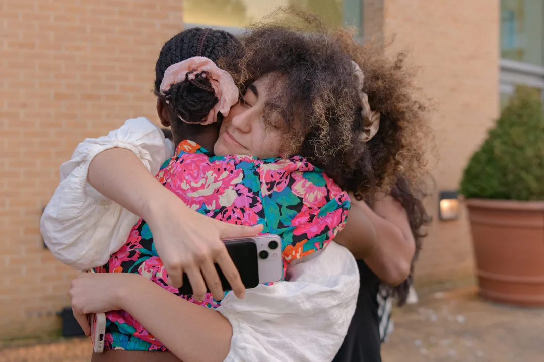 Two teenagers hugging