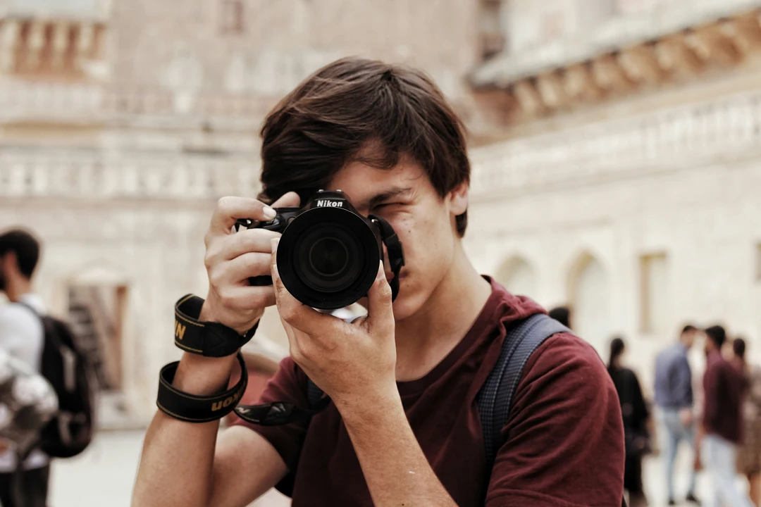 Young photographer holding up a camera to their face