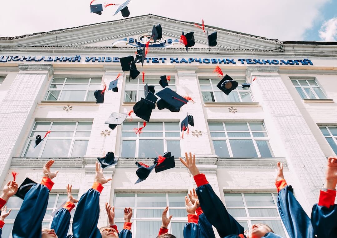 University graduates tossing their caps