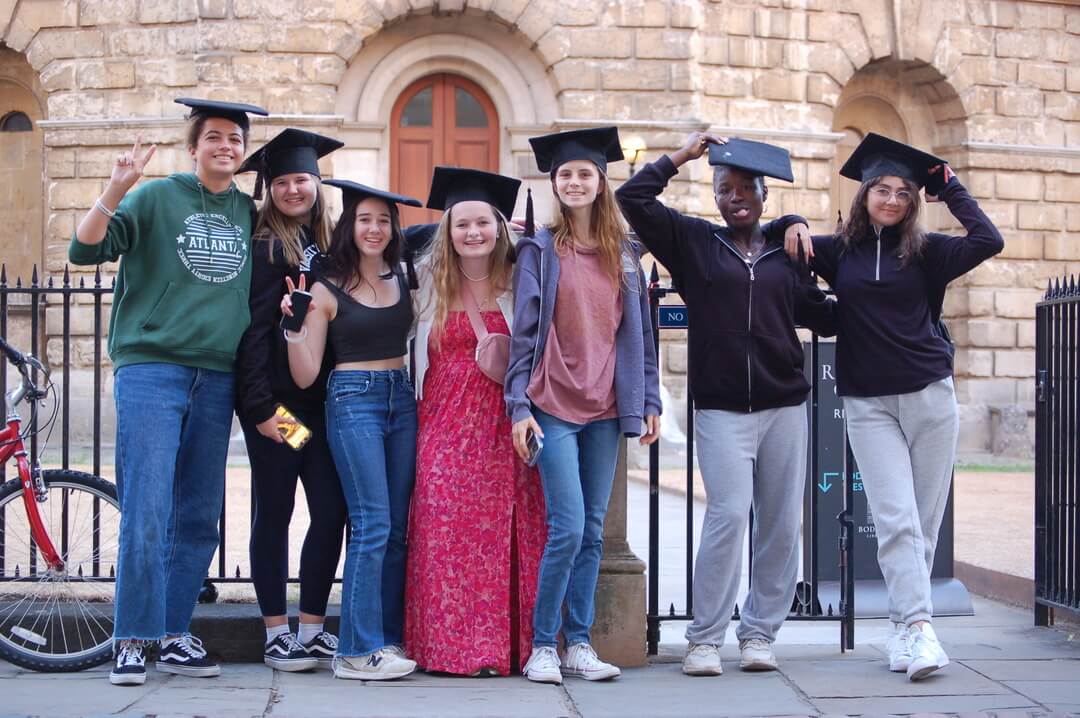 Oxford Scholastica Academy students with mortarboards outside of the Radcliffe Camera