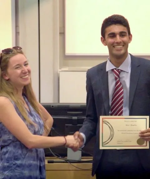 An Oxford Scholastica tutor congratulating an Experience Business Academy student.