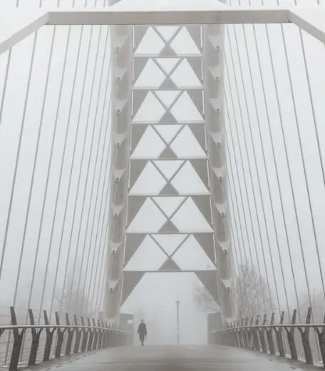 A picture of a bridge in the fog.