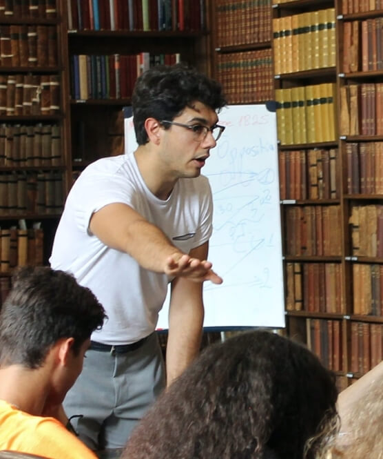 A tutor giving the students a few points about the work at an Oxford Scholastica summer school.