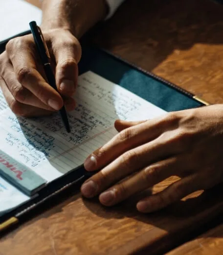 A person writing something in a notebook