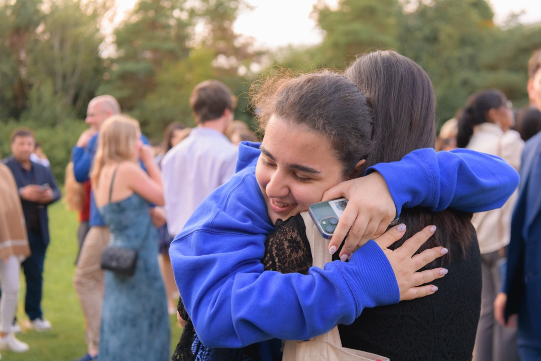 Two Oxford Scholastica students hugging at graduation