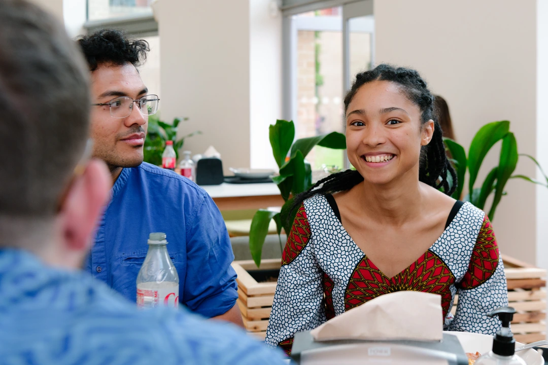 Two Oxford Scholastica tutors sitting at a table, smiling