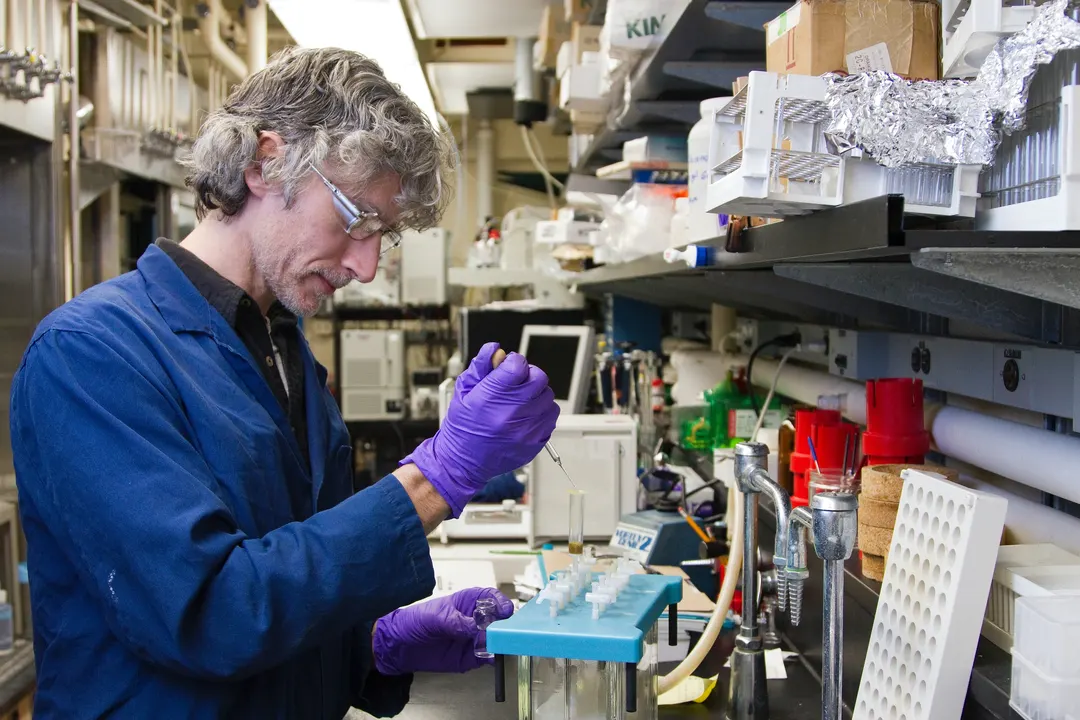 Chemical Engineer conducting an experiment with test tubes