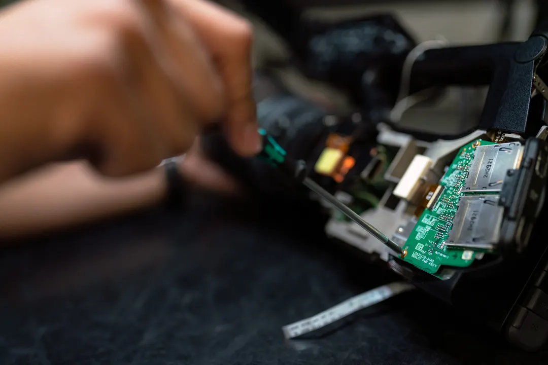Close up of an Electrical Engineer working on the circuitry of a camera