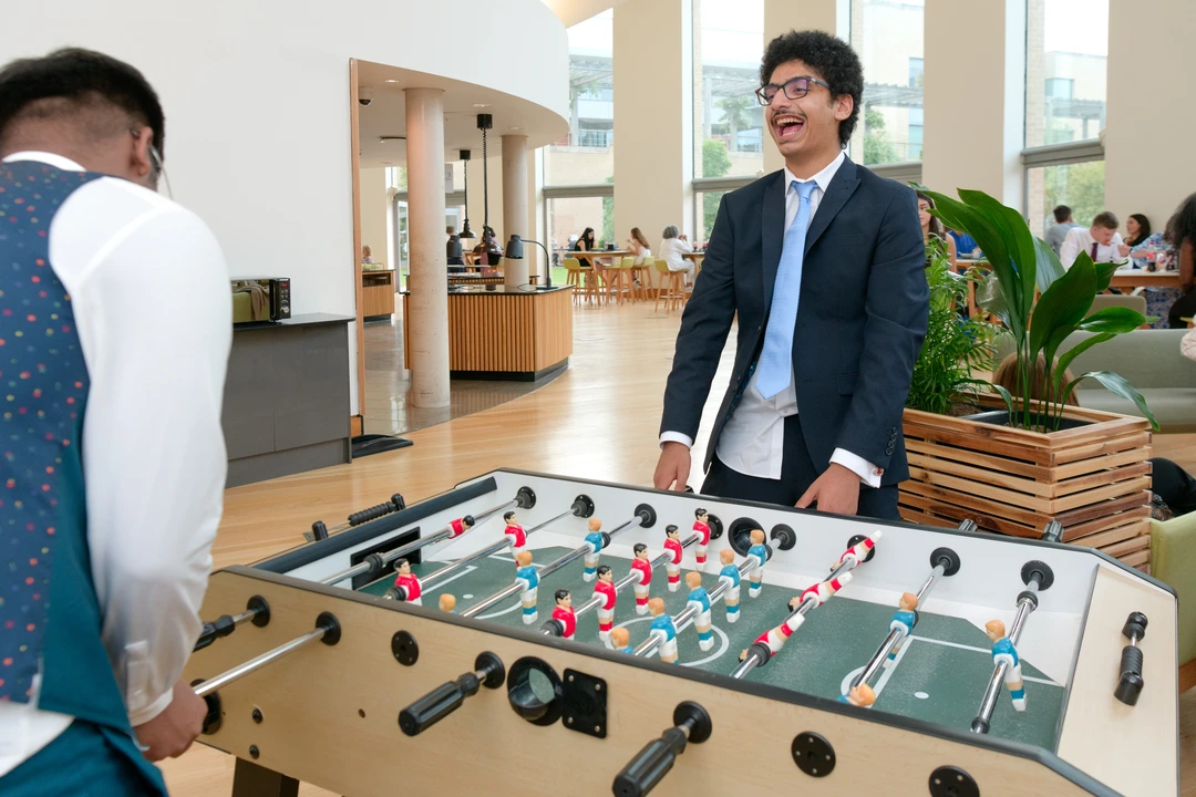 Two Oxford Scholastica students playing foosball and laughing