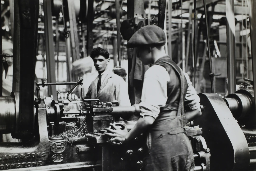 Greyscale photo of two workers in an aeronautics factory