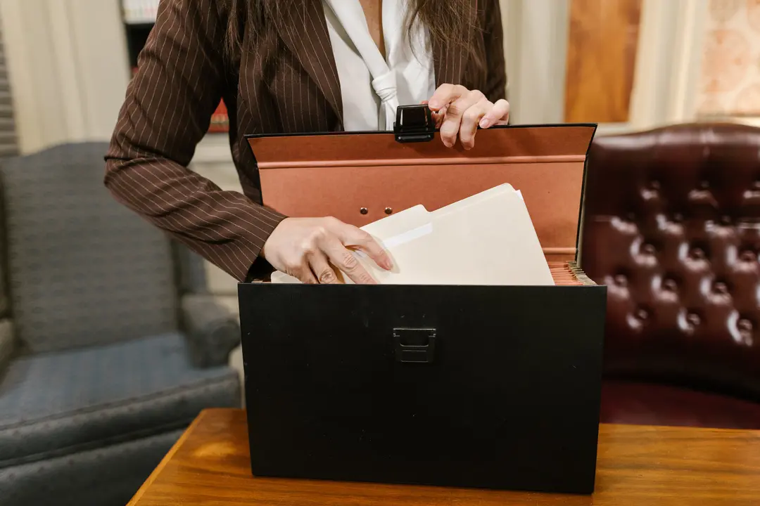 Lawyer placing documents into a briefcase