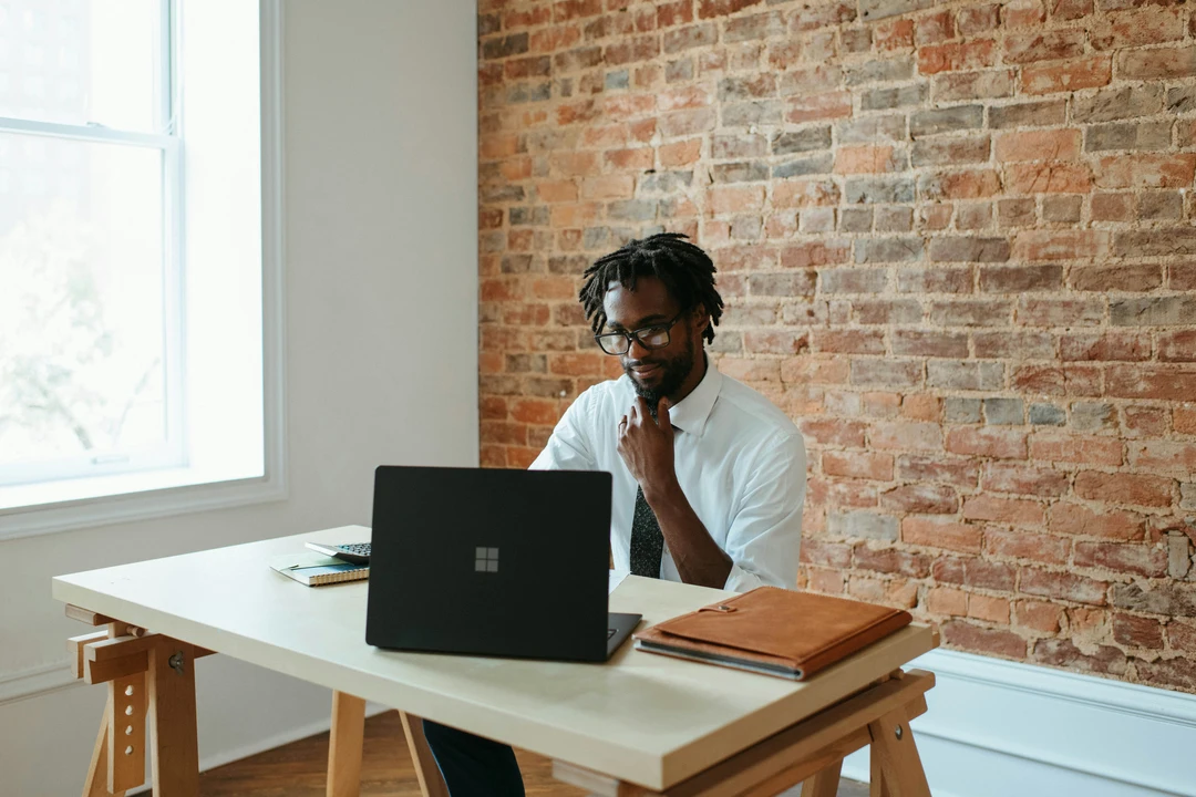 Modern businessman sitting at a laptop