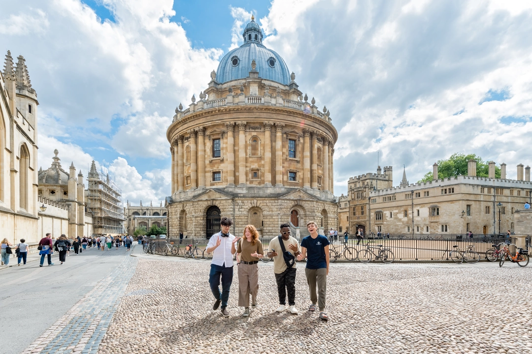 Four students walking in front of the Radcliffe Camera in Oxford