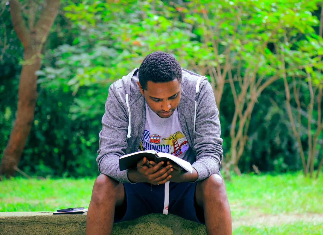 Person reading a book outside