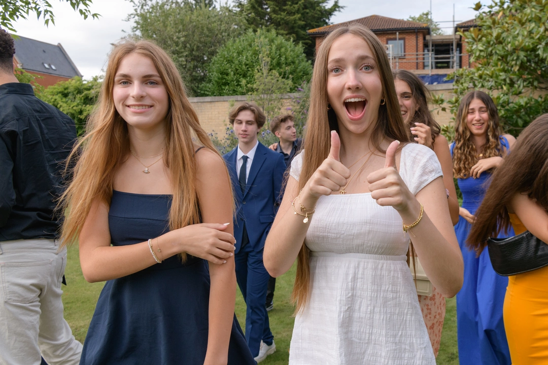 Teens showing thumbs ups to the camera