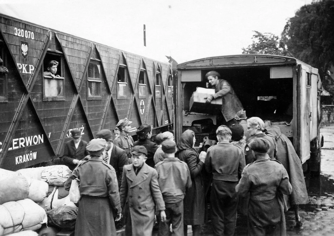 Greyscale photo of people queuing for supplies during World War II