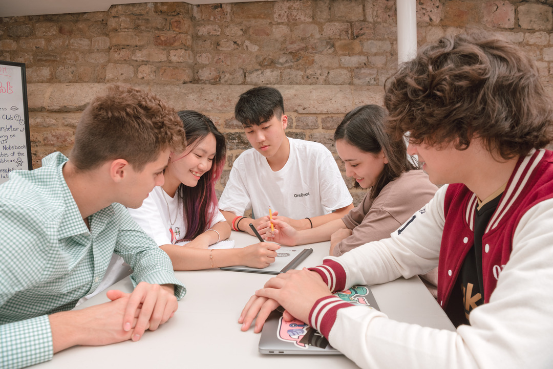 A group of OSA students chat during summer school