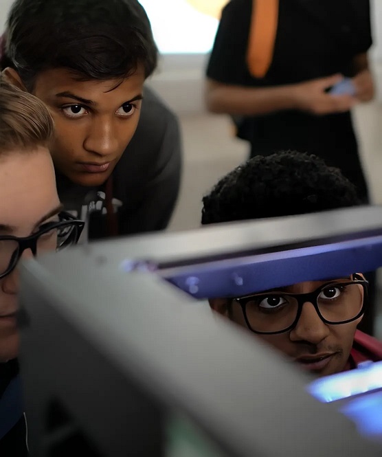Students looking at 3D printer