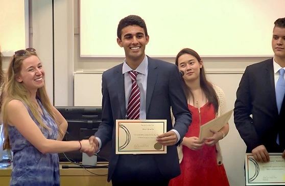 Student receiving graduation certificate