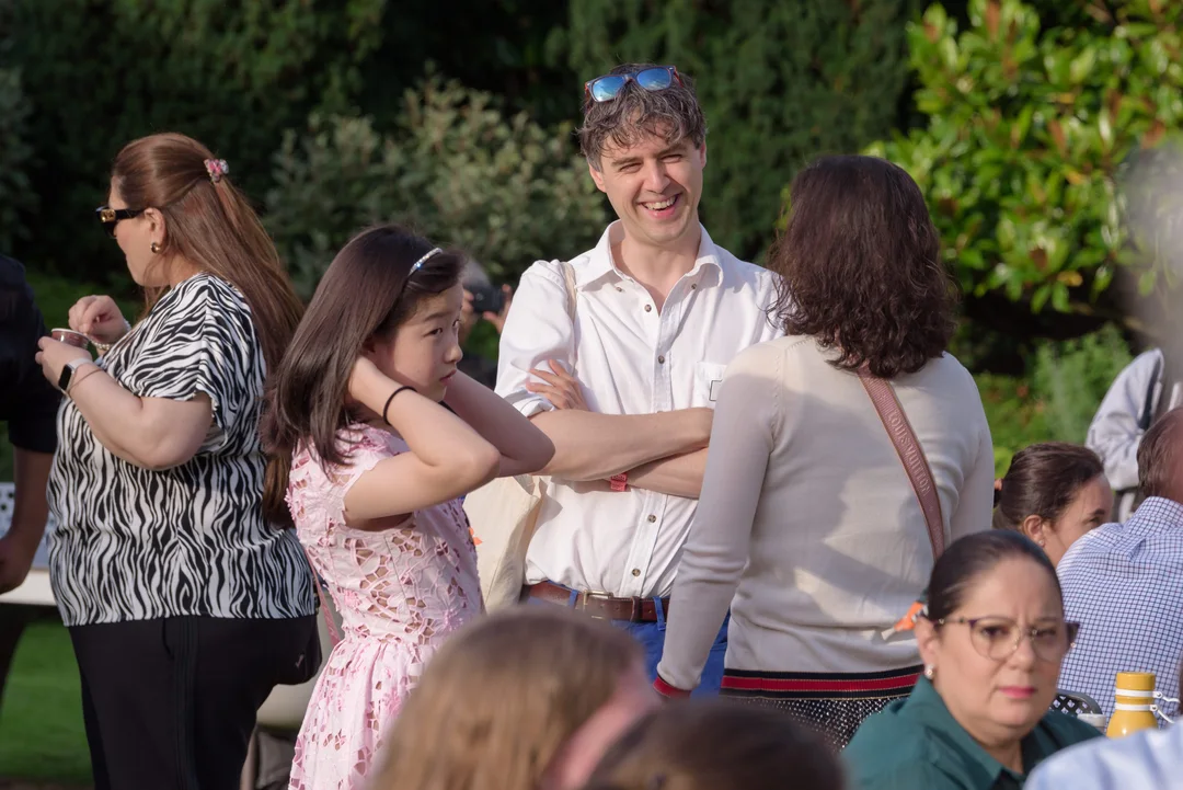 Jamie, Co-Director, talking to a parent at graduation