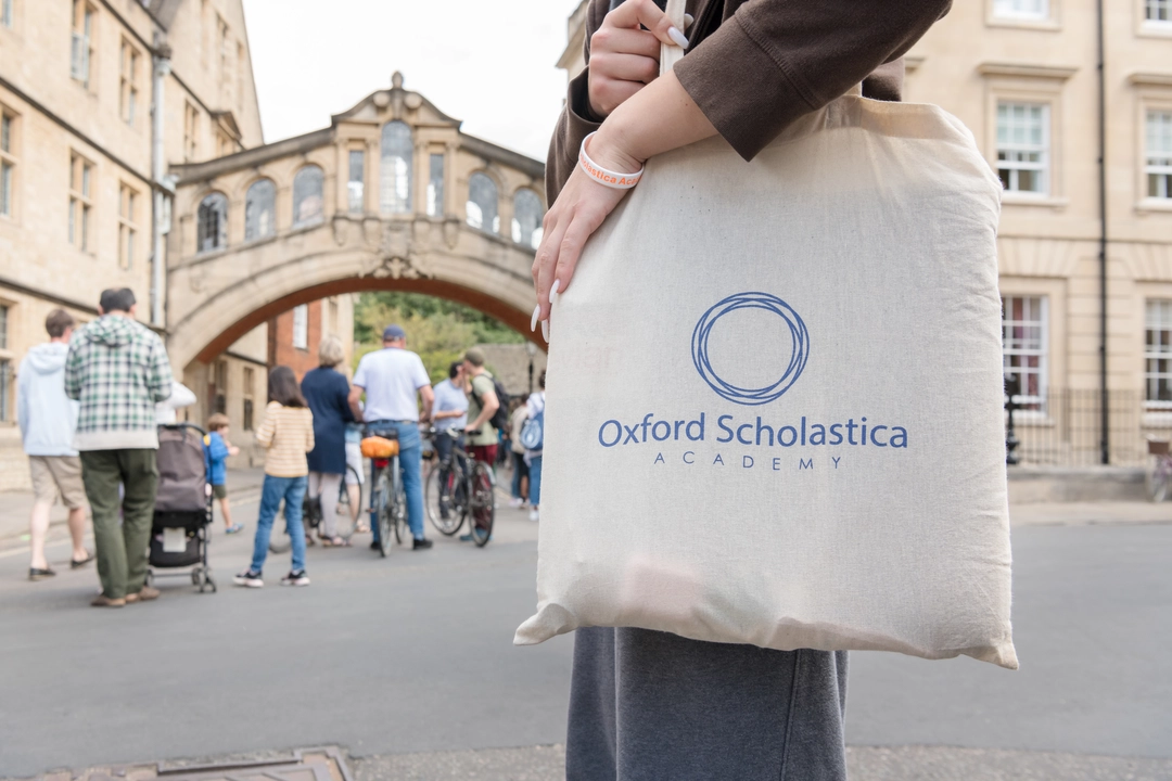 Close up of an Oxford Scholastica Academy bag with the Bridge of Sighs in the background
