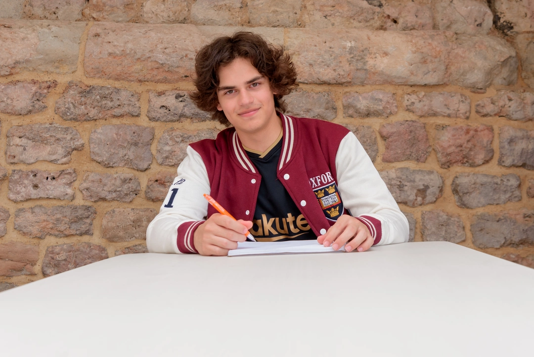 Oxford Scholastica student sitting at a desk with notepad and pen