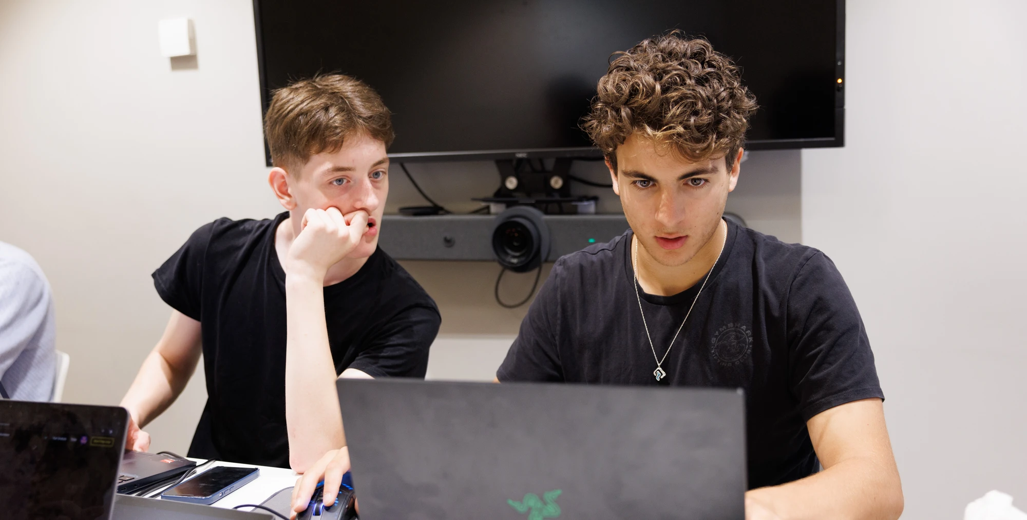 Two students working on a laptop